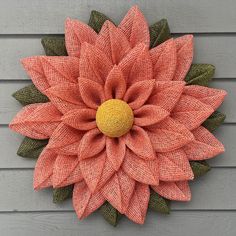 a large orange flower on the side of a building