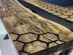 a table made out of wood with black and white designs on it's surface