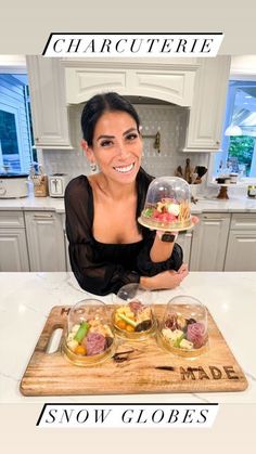 a woman sitting at a kitchen counter holding a glass bowl filled with salad and fruit