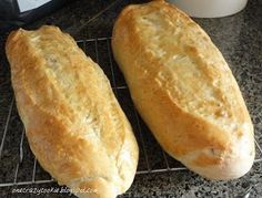 two loafs of bread cooling on a rack