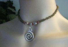 "This hemp necklace design is created using a spiral weave featuring a 1\" silver metal swirl attached to a silver metal bail with tiny swirls and wooden beads accents. This necklace is finished with a double loop and wooden bead closure. The color featured is Sage hemp and is available in several other color choices. 1/75" Interesting Necklace, Hemp Choker, Spiral Necklace, Hemp Necklace, Necklace Design, Funky Jewelry, Swag Style, Circle Of Life, Adjustable Necklace