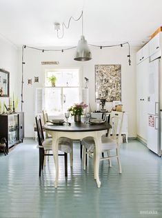 a kitchen with a table and chairs in it