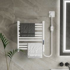 a bathroom with a sink, mirror and towel rack on the wall next to it