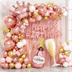 a pink and gold birthday party with balloons, champagne bottle, streamers and confetti