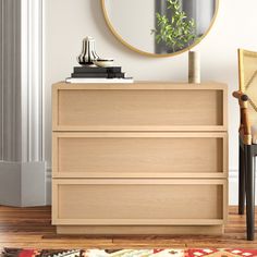 a wooden dresser with a mirror above it