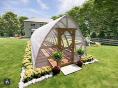 a small greenhouse sitting on top of a lush green field