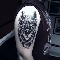 a man with a wolf tattoo on his arm