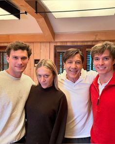 three men and a woman posing for a photo