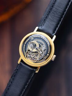 Our exclusive Raketa Skeleton customized handcrafted watch is a stunning display of  craftsmanship and attention to detail. It features an open skeleton design, revealing the intricate workings of the movement underneath. The exposed mechanism is meticulously finished with golden gears and components, creating a beautiful contrast against the steel case and surrounding elements. This exquisite vintage skeleton wristwatch is a remarkable showcase of intricate craftsmanship and timeless design. Th Classic Anniversary Watch With Rotating Bezel, Formal Watches With Rotating Bezel, Classic Formal Watch With Rotating Bezel, Steampunk Style Watch With Subdials As Gift, Vintage Skeleton Dial Pocket Watch As Gift, Gold Skeleton Dial Watch Accessories, Gold Watch Accessories With Skeleton Dial, Vintage Pocket Watch Gift, Gold Round Watch With Skeleton Dial