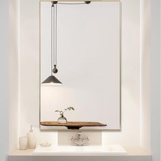 a bathroom sink with a mirror above it and a vase on the counter in front of it