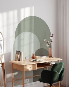 a wooden desk topped with a laptop computer next to a green chair