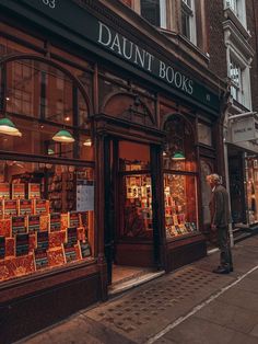 a man standing in front of a book store