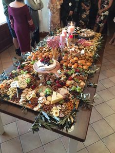 a table topped with lots of different types of food and desserts on top of it