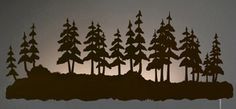 the silhouettes of trees are shown against a dark background