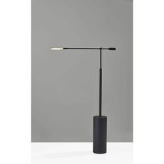 a black table lamp with a white light on the top and one arm in front of it