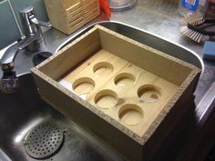 an open box sitting on top of a kitchen sink