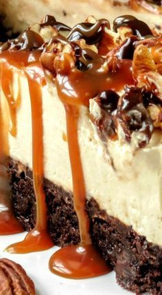 a piece of cheesecake with pecans and caramel drizzle on top