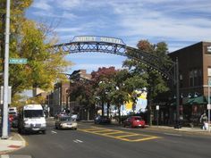 cars are driving under an overpass on a city street