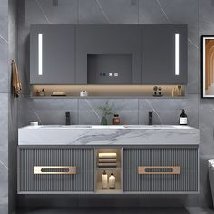 a bathroom with grey cabinets and marble counter tops