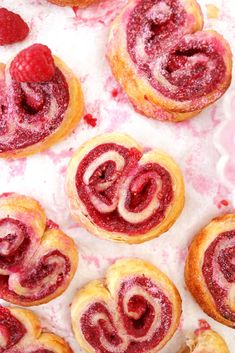 raspberry swirl pastries with powdered sugar and fresh raspberries on top