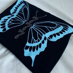 a black and blue blanket with a butterfly on it