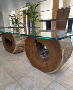 a table made out of wood and glass with a plant in the center on top