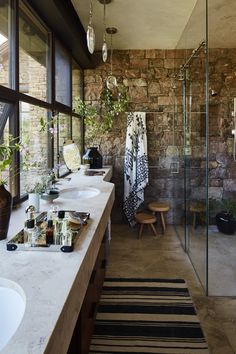 a bathroom with two sinks and a large mirror on the wall next to each other