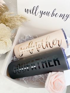 two personalized lip bales in a gift box next to flowers and a card