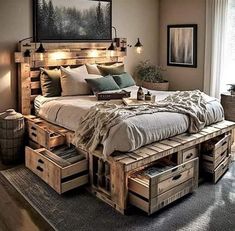 a bed made out of wooden crates with lights on each side and drawers underneath it