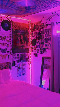 a bedroom with purple lighting and pictures on the wall