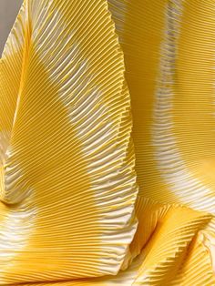 yellow and white pleated fabric with wavy lines