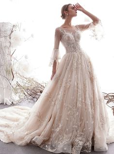 a woman in a wedding dress posing for the camera with her hand on her head