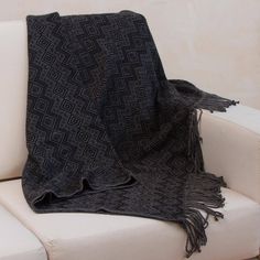 Beautiful diamond motifs in colors of smoke grey and black decorate this warm durable throw blanket presented by Nestor Yana of Peru. The comfortable throw is woven from an acrylic and alpaca blend finished with fringes on the ends. Black Throws, Fair Trade Clothing, Wool Poncho, Black Gifts, Flip Flop Shoes, Dining Accessories, Handmade Blanket, Black Diamonds, Plum Color