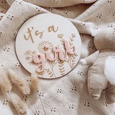 it's a girl wooden sign with flowers and birds on the front next to a teddy bear