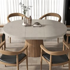 a round table with four chairs around it and a vase on the table in front of it