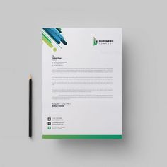 a business letterhead with green and blue lines on it next to a black pen