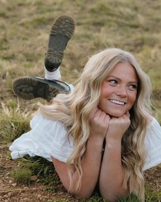 a woman laying on the ground with her legs crossed