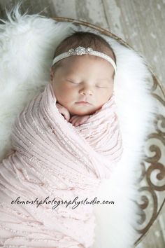 a newborn baby wrapped in a pink blanket