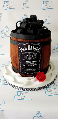 a birthday cake made to look like a barrel with a rose on top and jack daniels logo