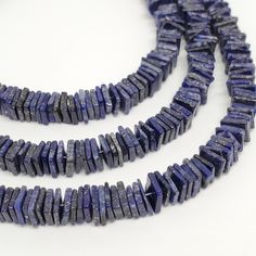 three strands of blue lapel beads on a white surface