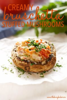 a mushroom topped with cheese and herbs on top of a piece of white parchment paper