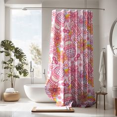 a bathroom with a pink shower curtain next to a bathtub