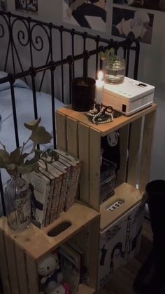 there is a bed made out of crates with books on it and a lamp in the corner