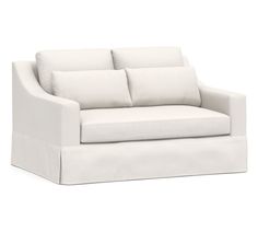 a white couch with four pillows on it