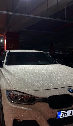 a white car parked in a parking garage