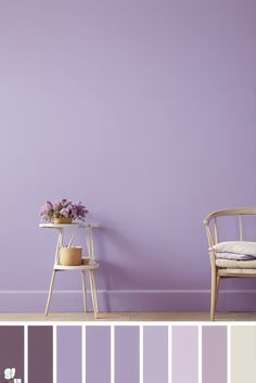 a chair and table in front of a purple wall