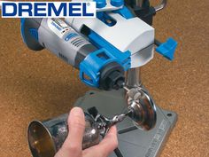 a man is using a driller on a piece of metal with the words dremel above it