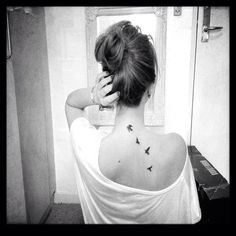 a woman with a bird tattoo on her back