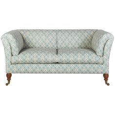 a blue and white patterned couch with wooden legs on an isolated white background for use in interior design