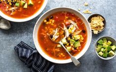 two bowls of vegetable soup on a table